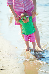 Image showing mom and baby on beach  have fun