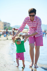 Image showing mom and baby on beach  have fun