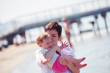 Image showing mom and baby on beach  have fun