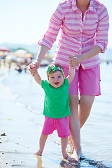 Image showing mom and baby on beach  have fun