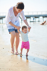 Image showing mom and baby on beach  have fun