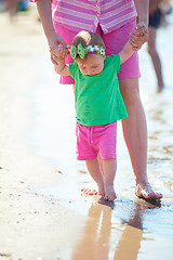 Image showing mom and baby on beach  have fun