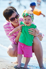 Image showing mom and baby on beach  have fun