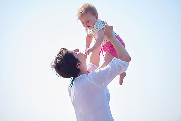 Image showing mom and baby on beach  have fun