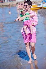 Image showing mom and baby on beach  have fun