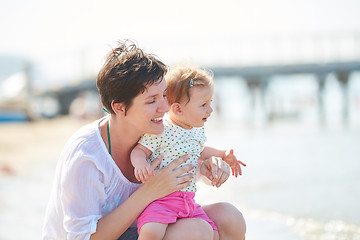 Image showing mom and baby on beach  have fun