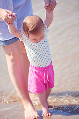 Image showing mom and baby on beach  have fun