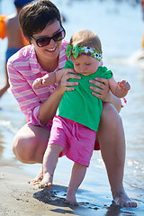 Image showing mom and baby on beach  have fun