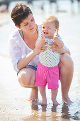 Image showing mom and baby on beach  have fun