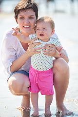 Image showing mom and baby on beach  have fun