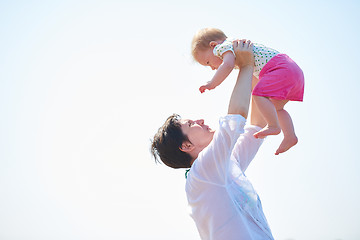 Image showing mom and baby on beach  have fun