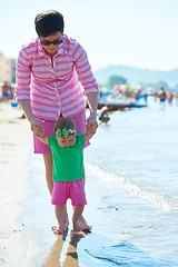 Image showing mom and baby on beach  have fun