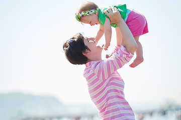 Image showing mom and baby on beach  have fun