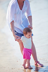 Image showing mom and baby on beach  have fun