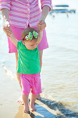 Image showing mom and baby on beach  have fun