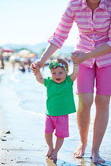 Image showing mom and baby on beach  have fun