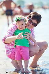 Image showing mom and baby on beach  have fun