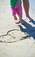 Image showing mom and baby on beach  have fun