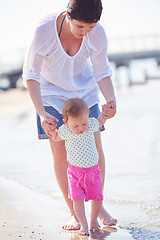 Image showing mom and baby on beach  have fun