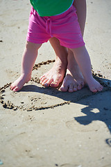 Image showing mom and baby on beach  have fun