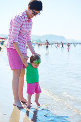 Image showing mom and baby on beach  have fun