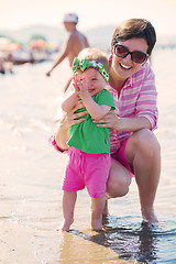 Image showing mom and baby on beach  have fun