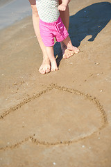 Image showing mom and baby on beach  have fun