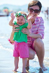 Image showing mom and baby on beach  have fun