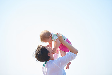 Image showing mom and baby on beach  have fun