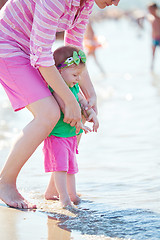 Image showing mom and baby on beach  have fun