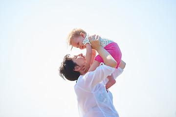 Image showing mom and baby on beach  have fun