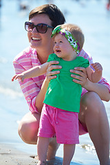 Image showing mom and baby on beach  have fun