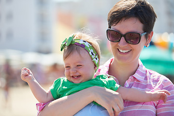 Image showing mom and baby on beach  have fun