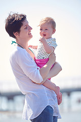 Image showing mom and baby on beach  have fun