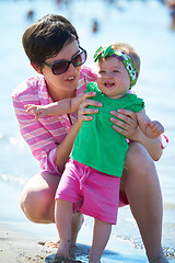 Image showing mom and baby on beach  have fun