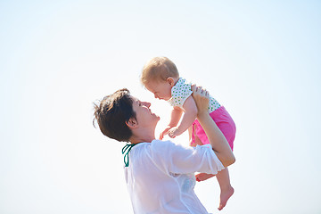 Image showing mom and baby on beach  have fun