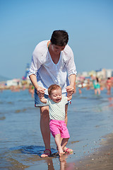 Image showing mom and baby on beach  have fun