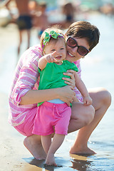 Image showing mom and baby on beach  have fun