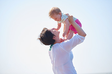 Image showing mom and baby on beach  have fun