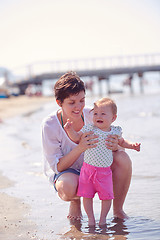 Image showing mom and baby on beach  have fun