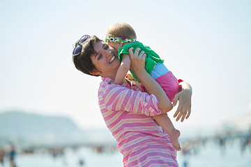 Image showing mom and baby on beach  have fun