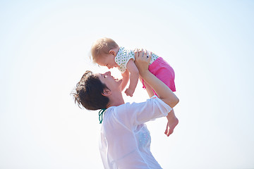 Image showing mom and baby on beach  have fun