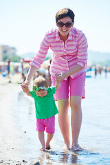 Image showing mom and baby on beach  have fun