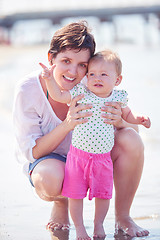 Image showing mom and baby on beach  have fun