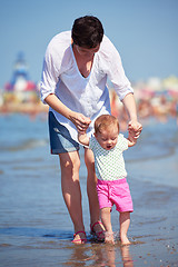 Image showing mom and baby on beach  have fun