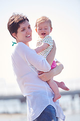 Image showing mom and baby on beach  have fun