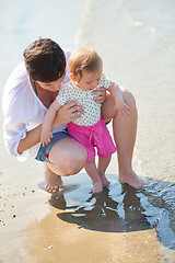 Image showing mom and baby on beach  have fun