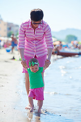 Image showing mom and baby on beach  have fun