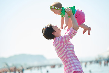 Image showing mom and baby on beach  have fun