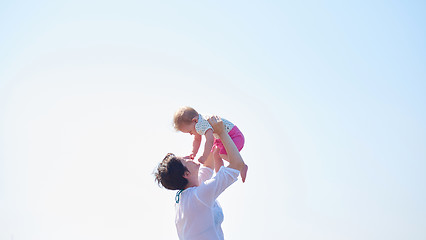 Image showing mom and baby on beach  have fun